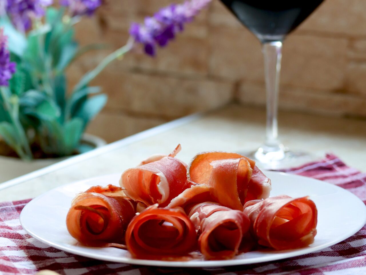 Local cured ham in Italy, served with a glass of wine