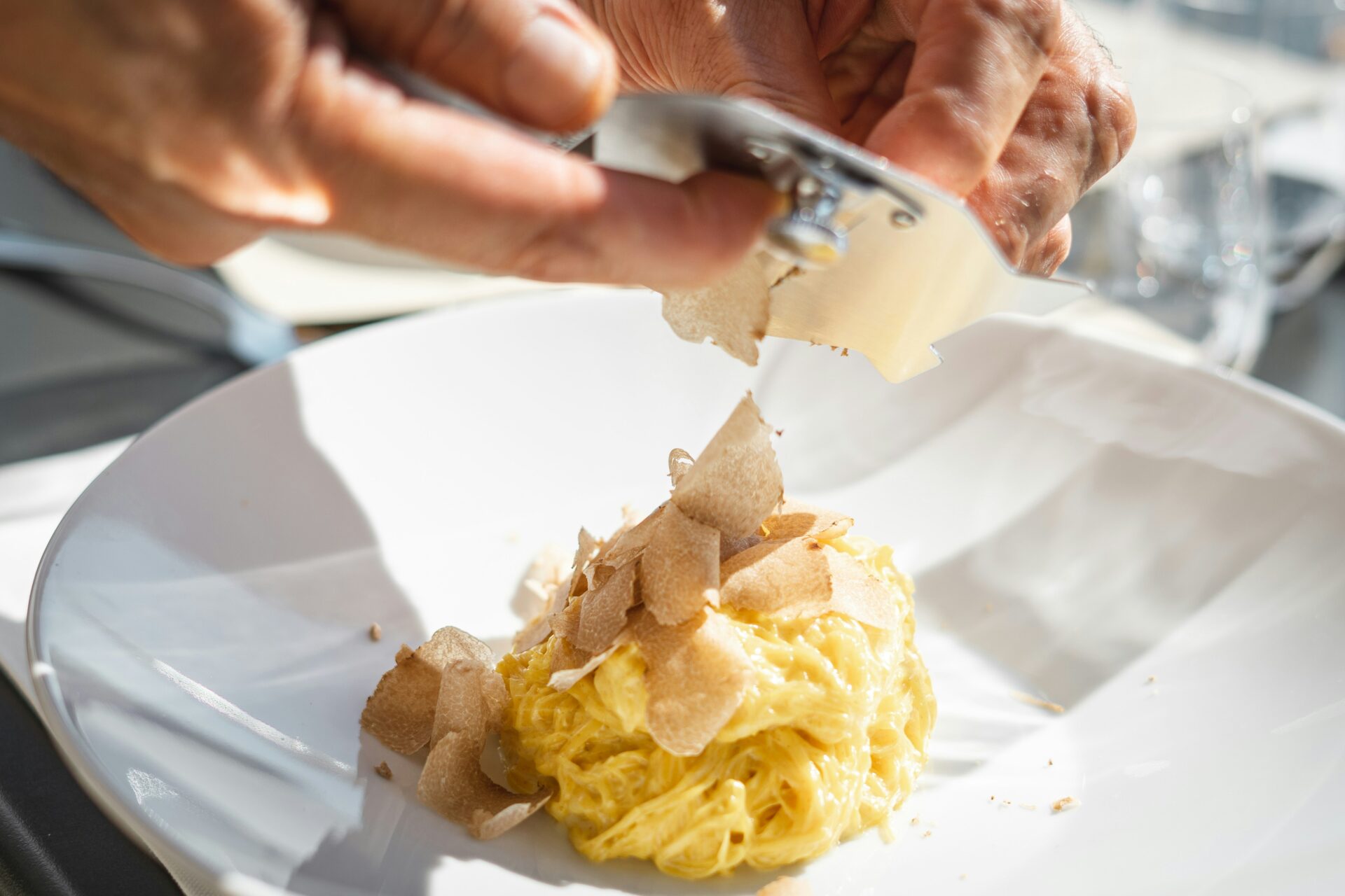 Plate of traditional egg noodles (tajarin) topped with freshly shaved Alba white truffle