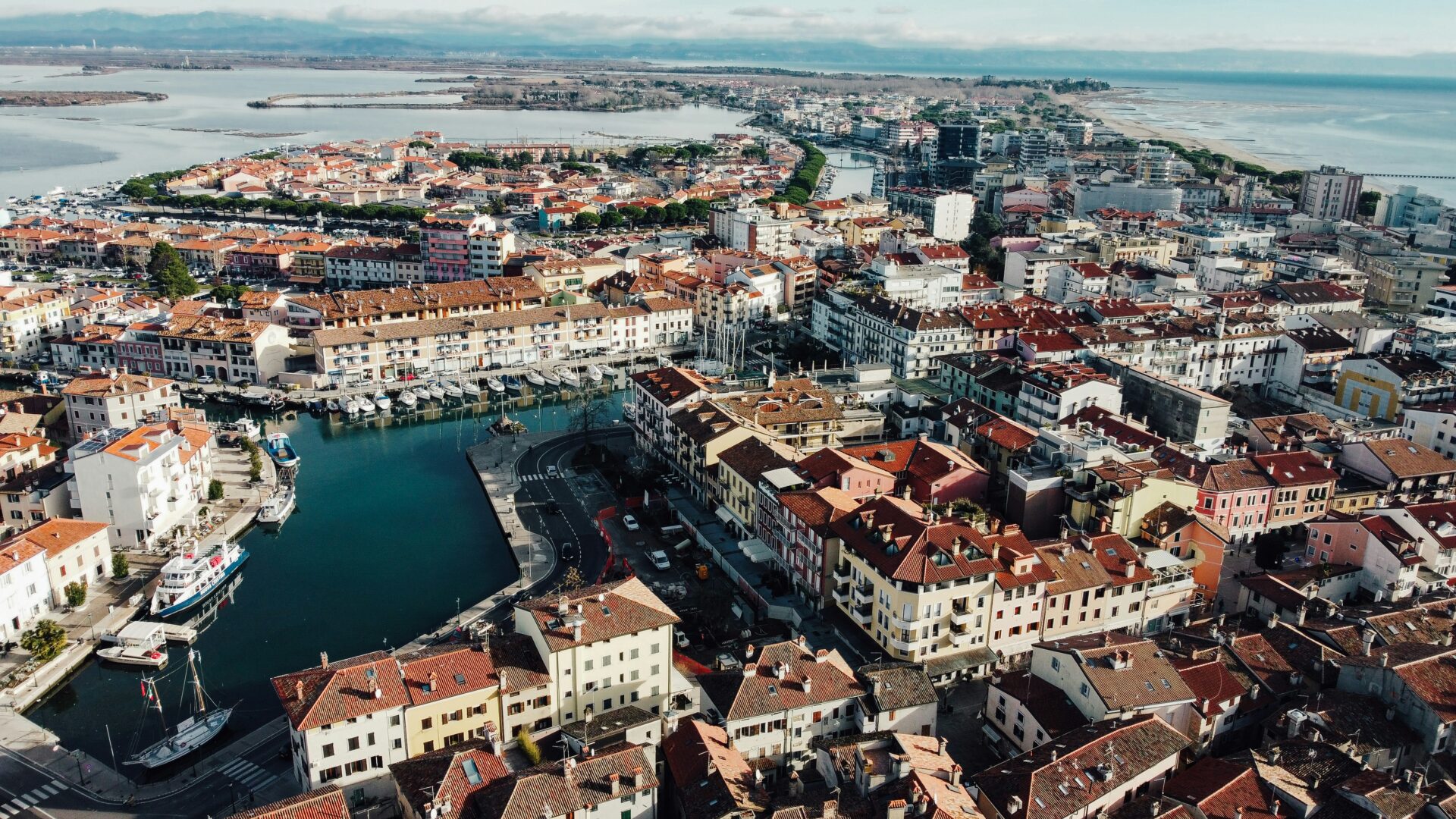 Aerial view of Grado, Italy, showcasing its historic village, surrounding lagoon, and scenic coastal landscape.
