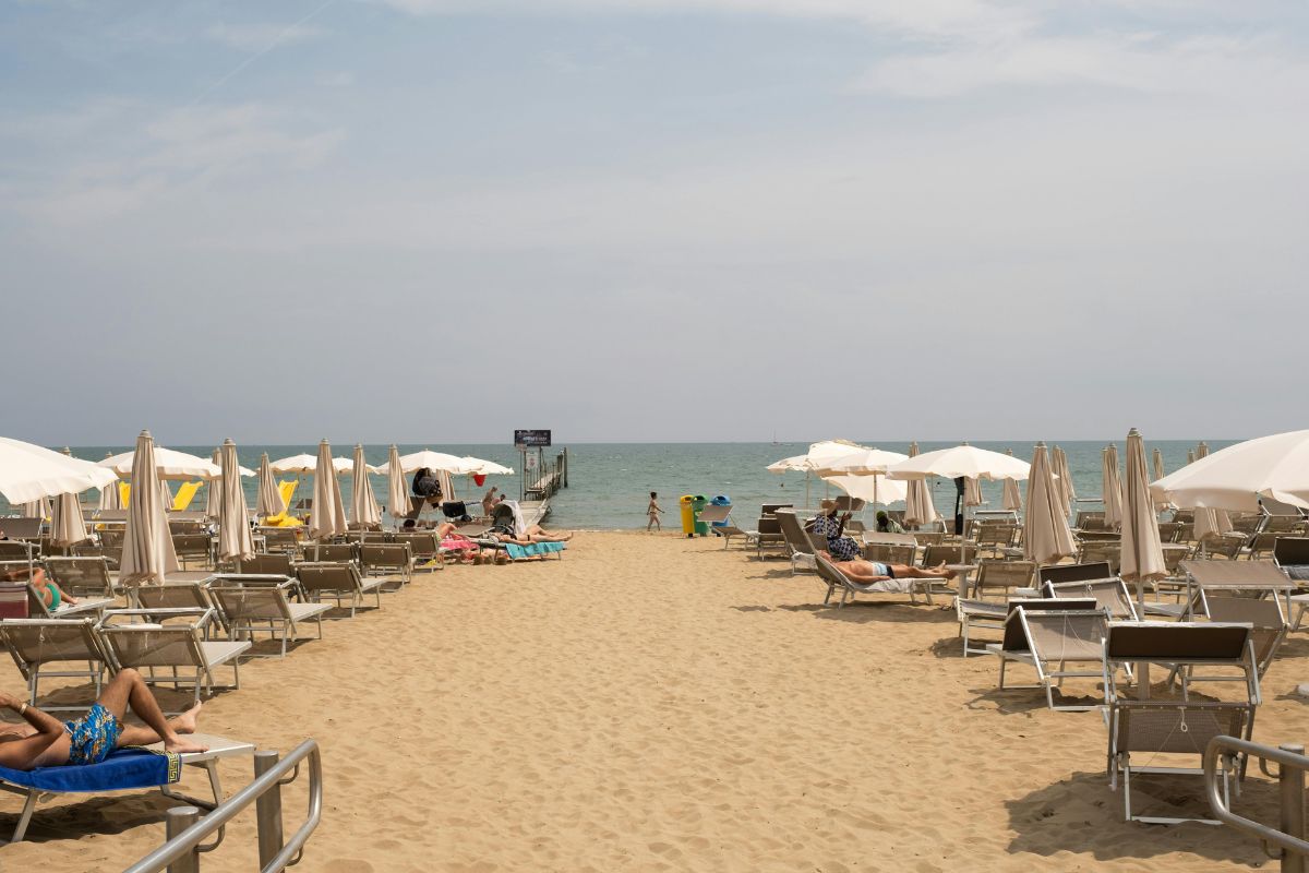 Tourists Sunbathing on Sun Loungers Set on the Lido di Jesolo beach, Veneto, Italy