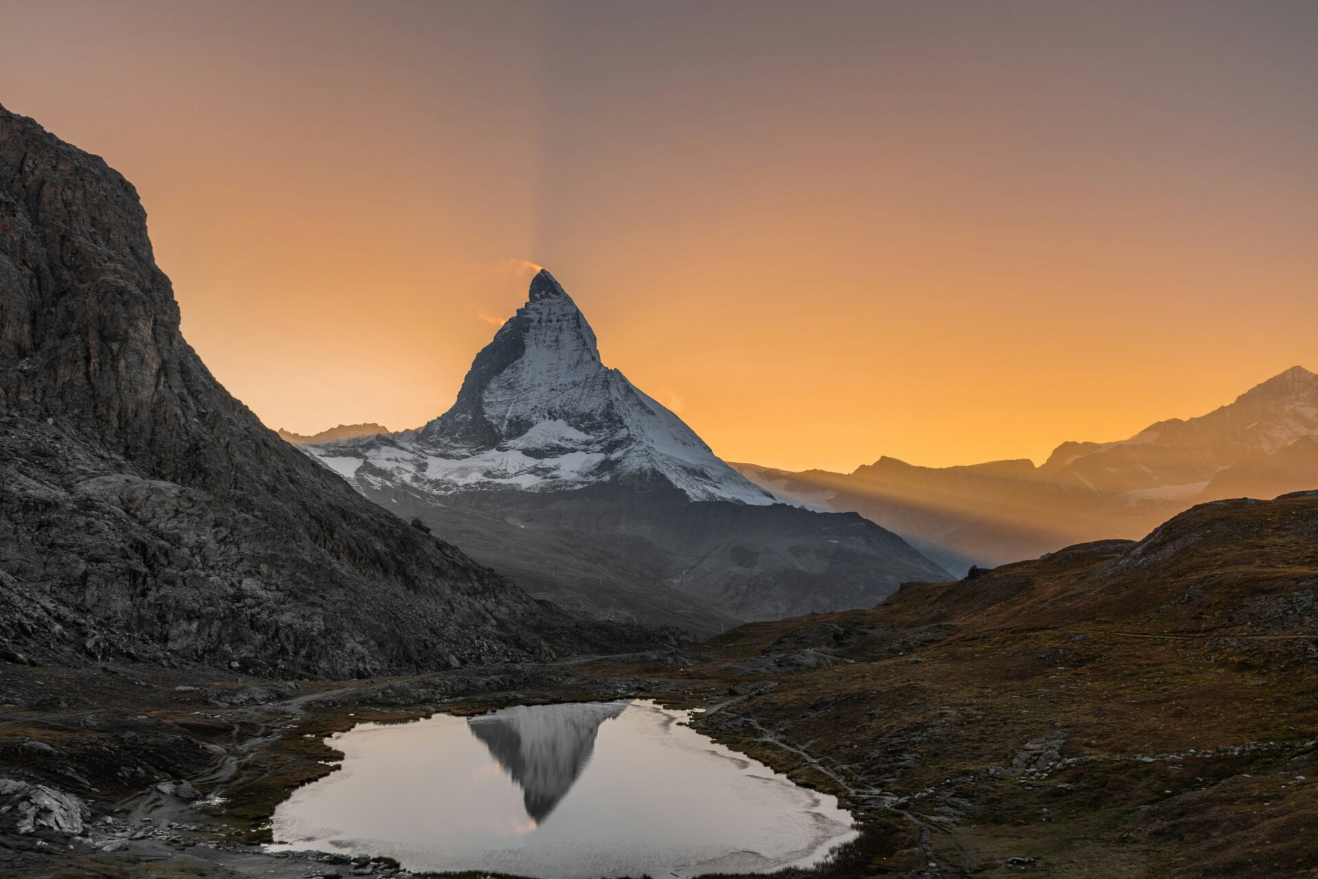 Pinkish-golden glow of Matterhorn during sunset.