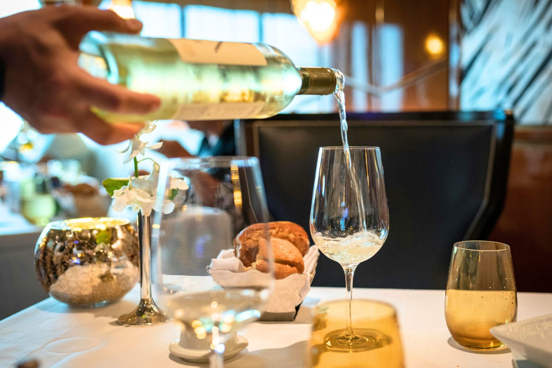 Italian white wine served on a wineglass - restaurant setting