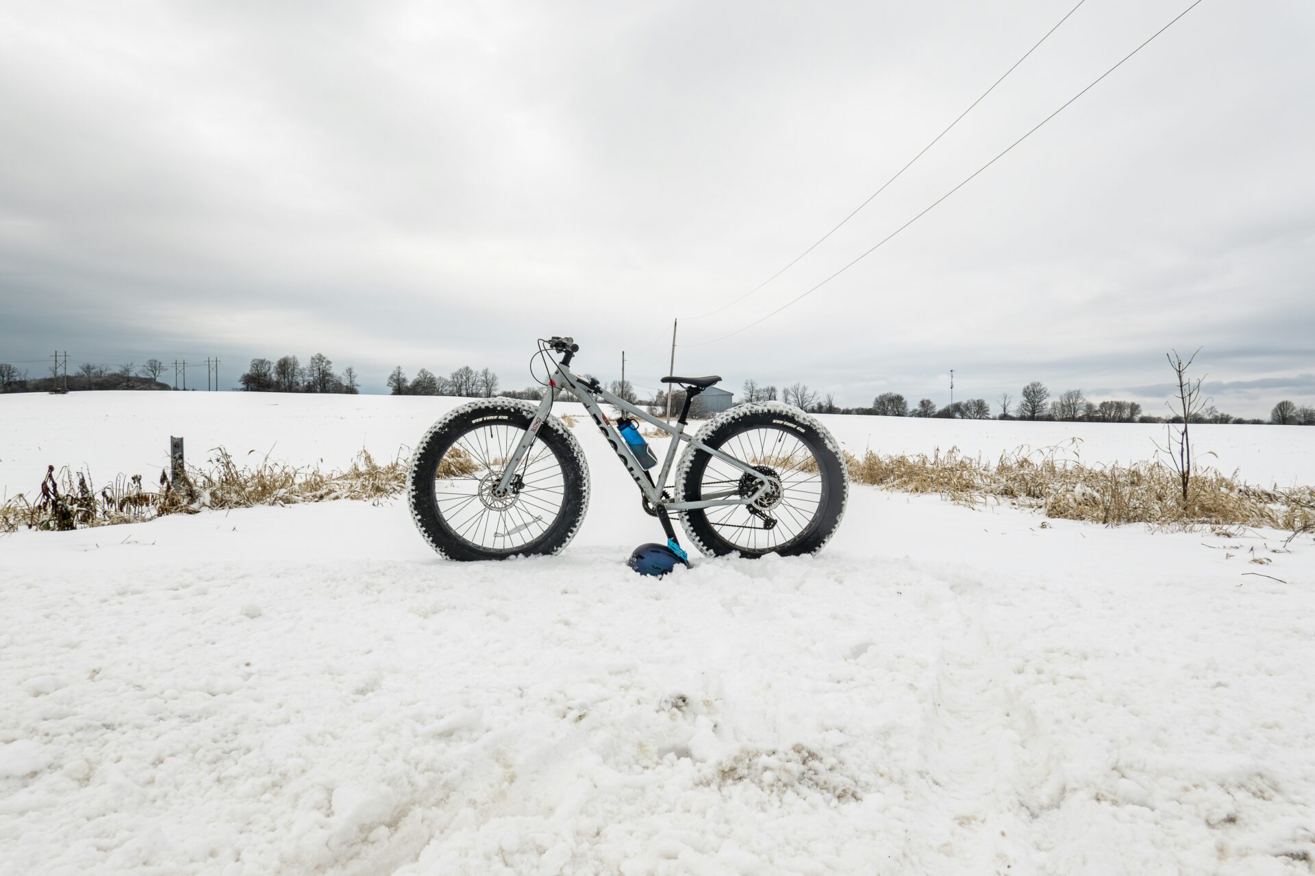 Fat bike in a snowy field. Bike with thick wheels used during winter.


