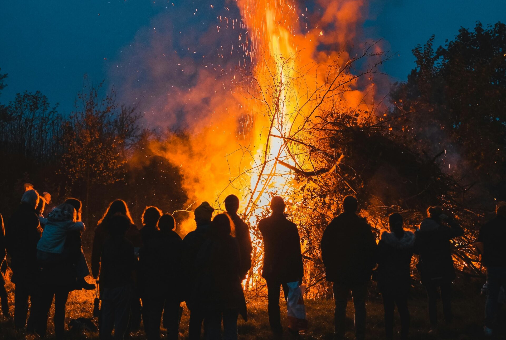 People Standing Near a Bonfire