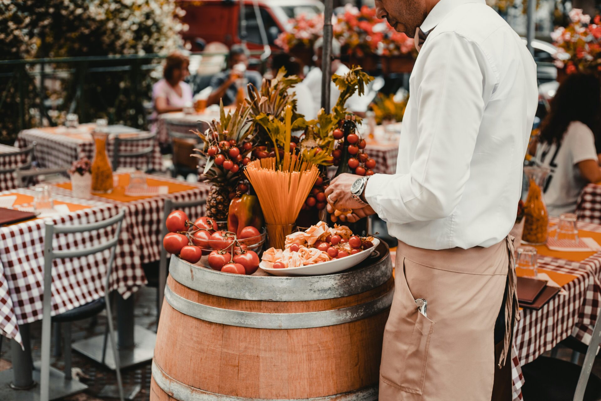 A barrel with fruits and pasta on top - Italian restaurant