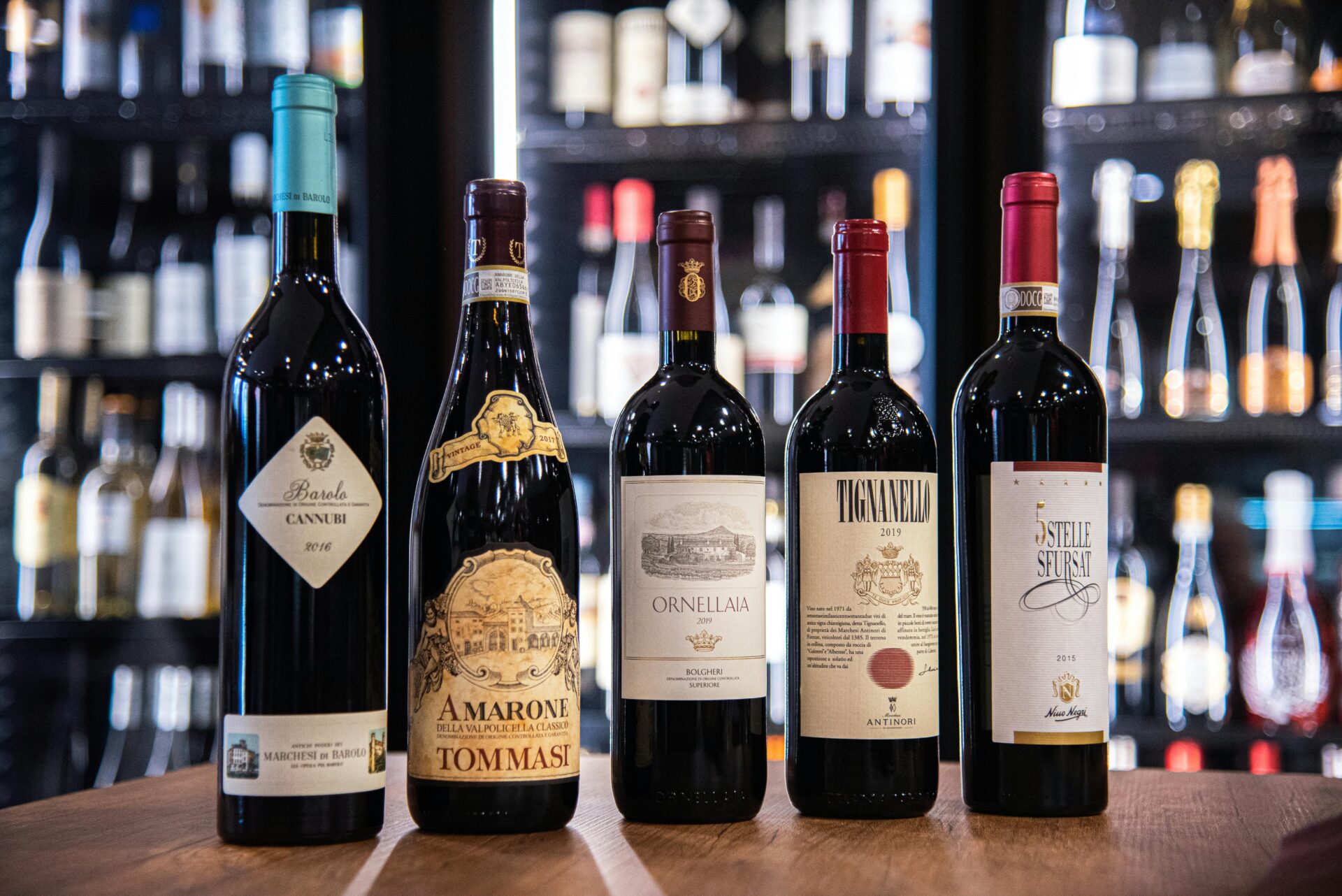 A group of six bottles of wine sitting on a table