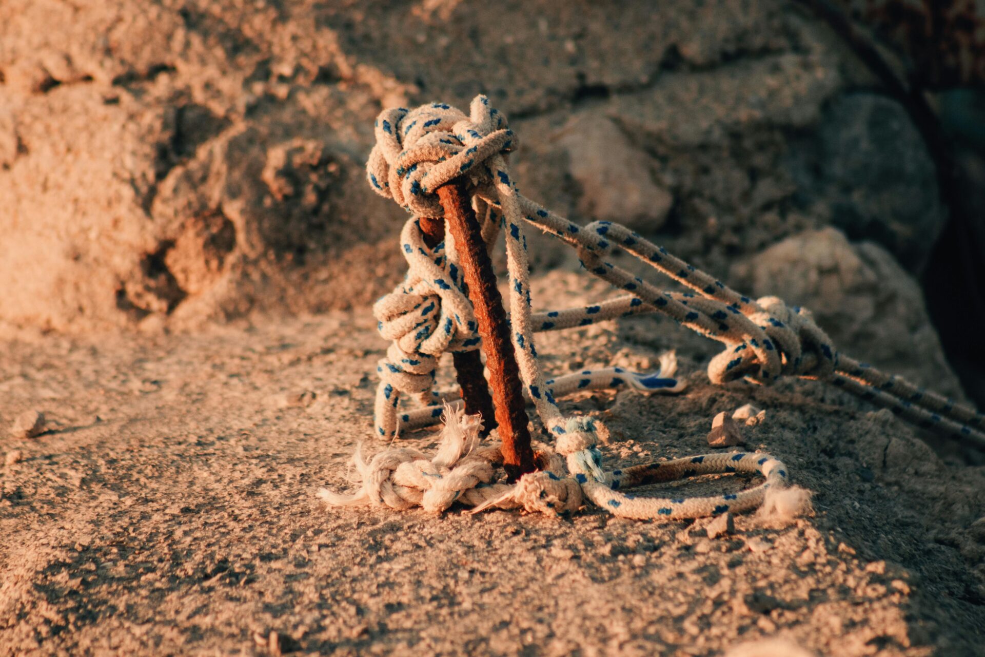 A rope and a metal stick on the ground