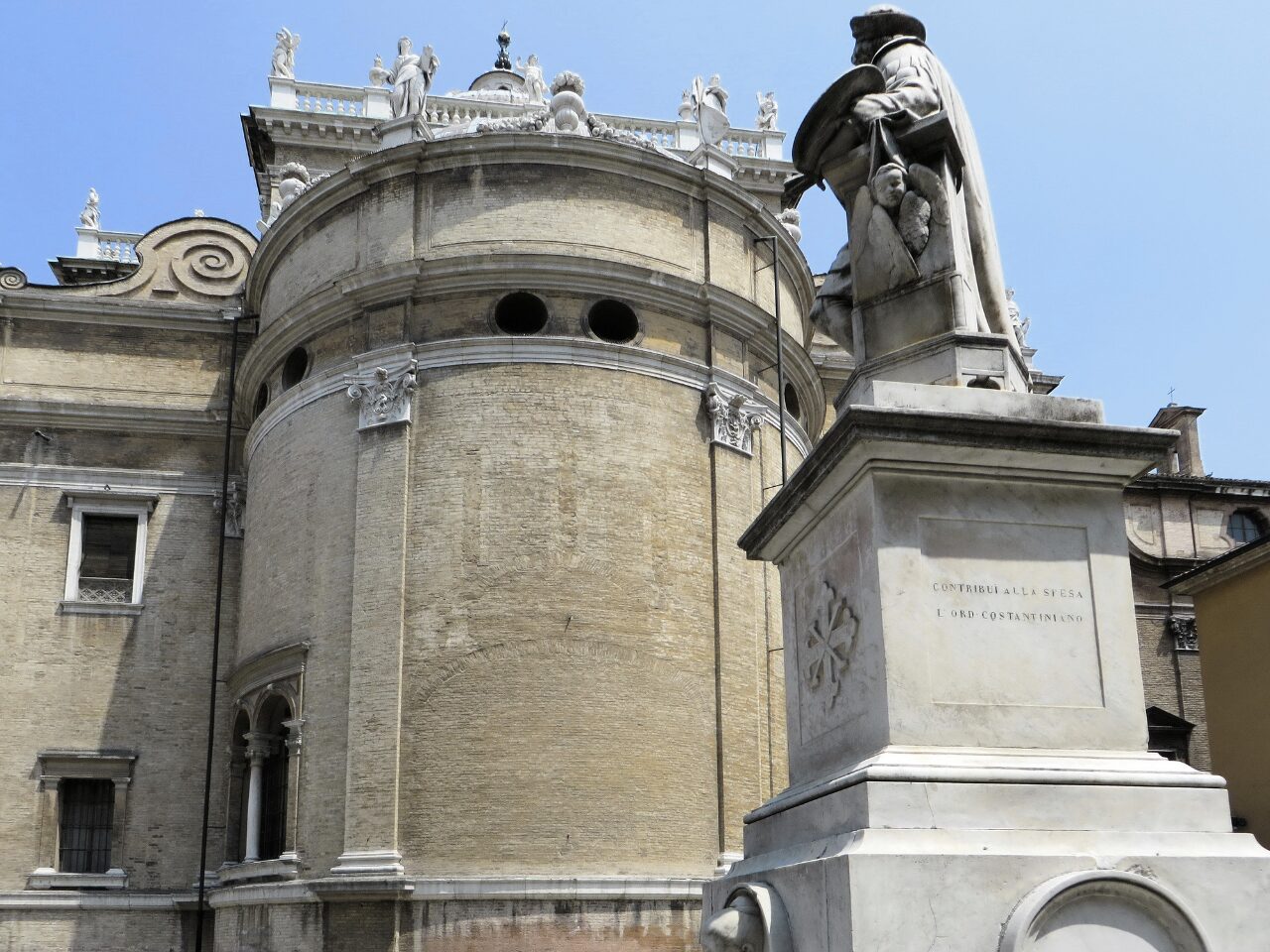 A statue and apse in Parma Italy.