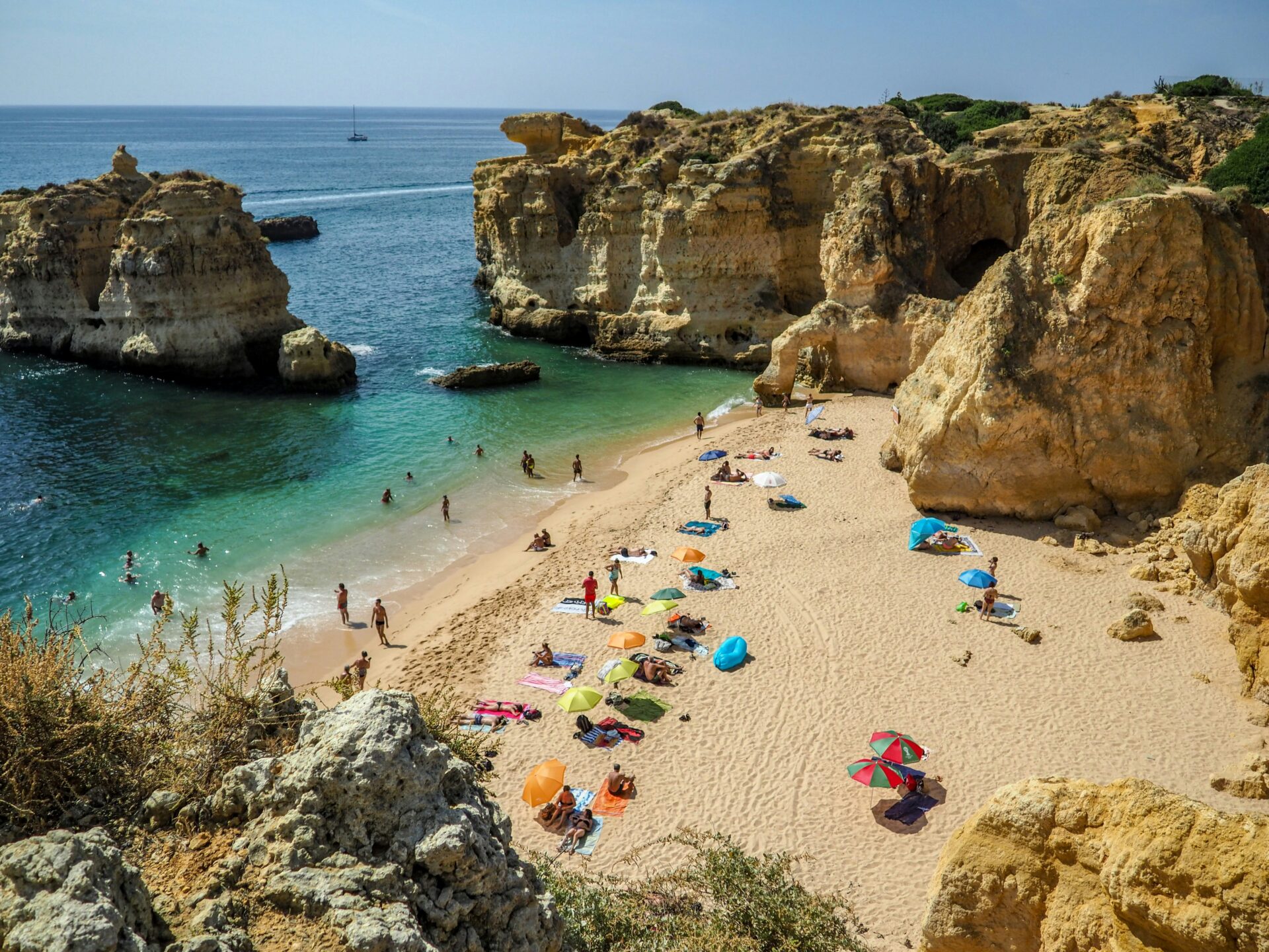 Beach in Algarve, Portugal with people sunbathing