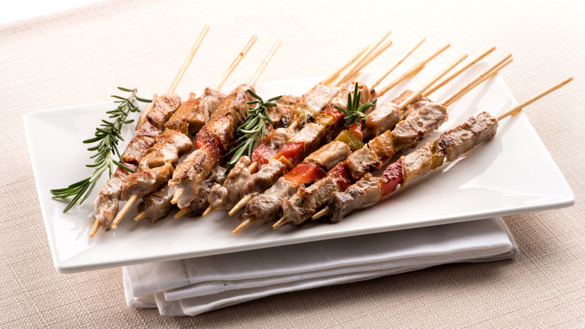 Image shows Arrosticini on a plate. 
