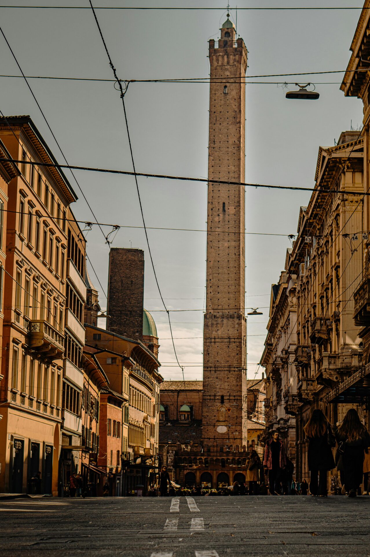 A view of the Asinelli and Garisenda Towers in Bologna, Emilia-Romagna, Italy, showcasing their striking medieval architecture.