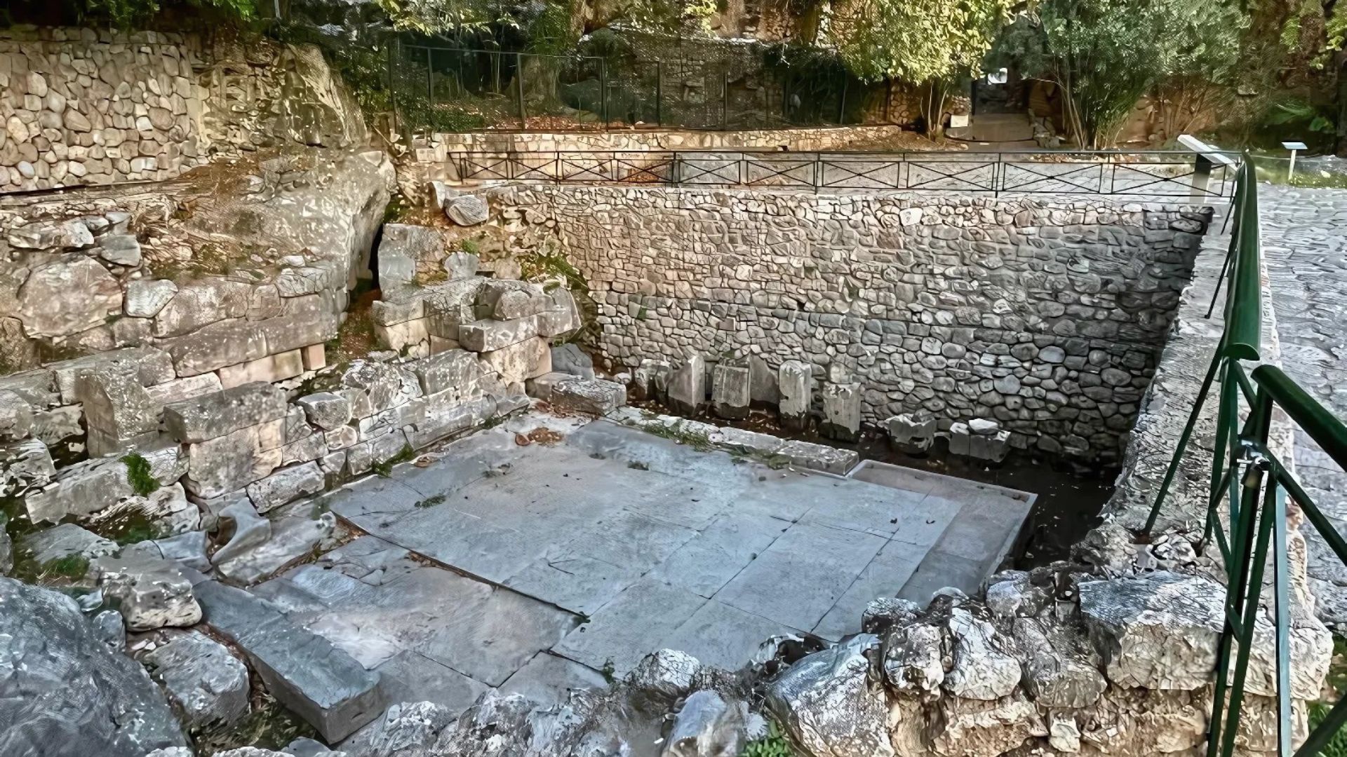 The image shows the Castalian Spring in Delphi, Greece