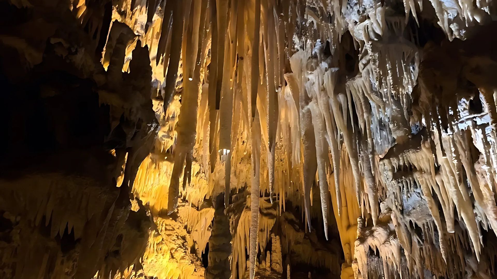 Image shows Black Cavern of Castellana Caves, Grotte di Castellana, Puglia, Italy showcasing its impressive geological formations.