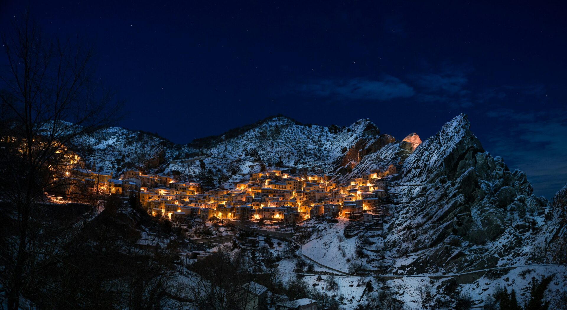 Golden light bathes the mountain village of Castelmezzano at night
