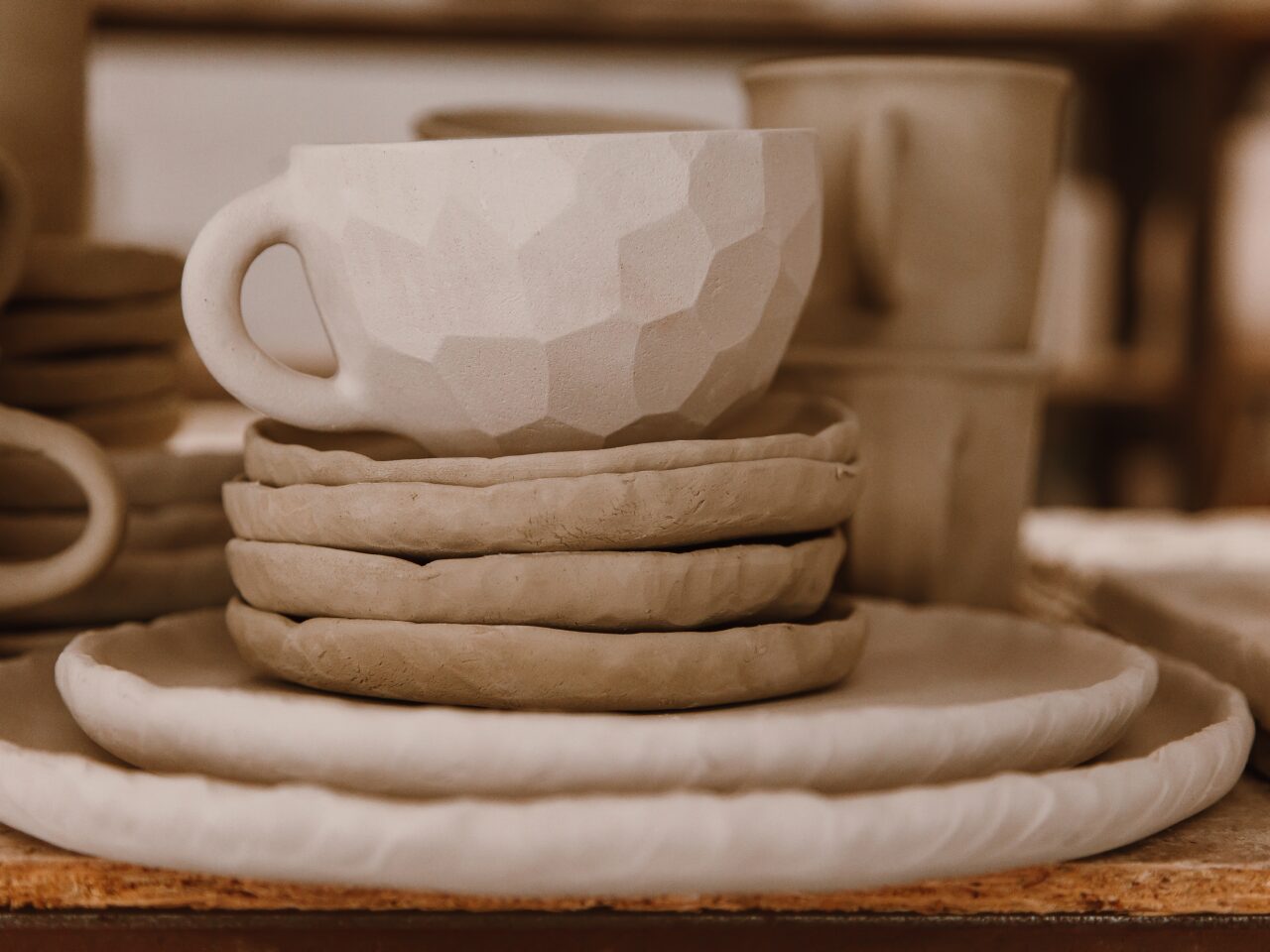 Ceramic mug on a stack of saucers - artisan ceramics
