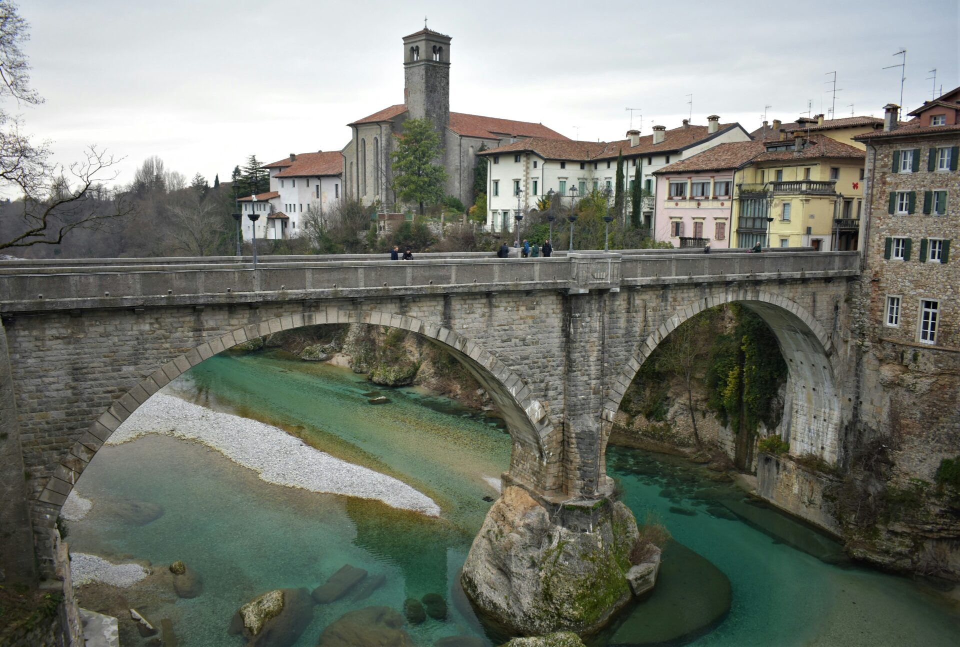 Scenic view of Cividale del Friuli, Italy, showcasing historic buildings, charming streets, and surrounding natural beauty in a peaceful hillside setting.