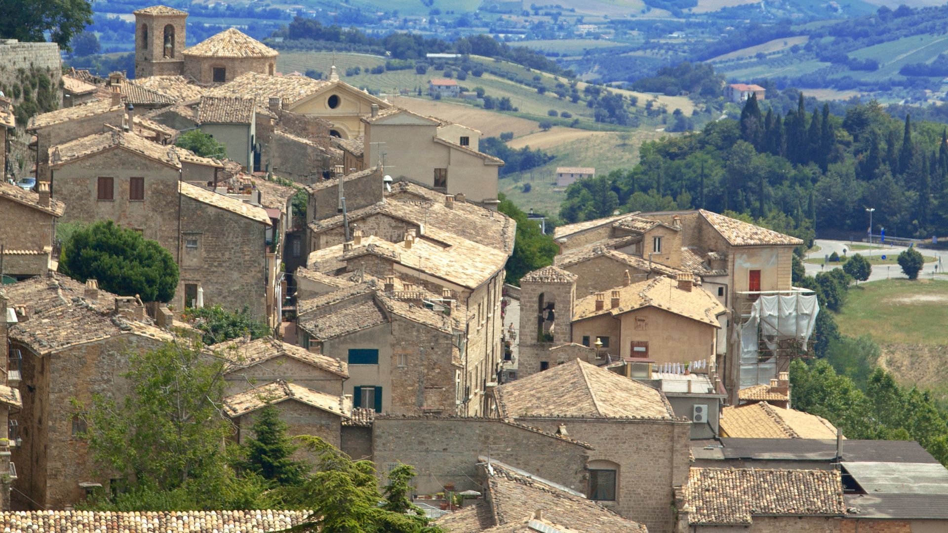 Image shows the view of Civitella del Tronto perched on a rocky cliff in Italy's Abruzzo region.