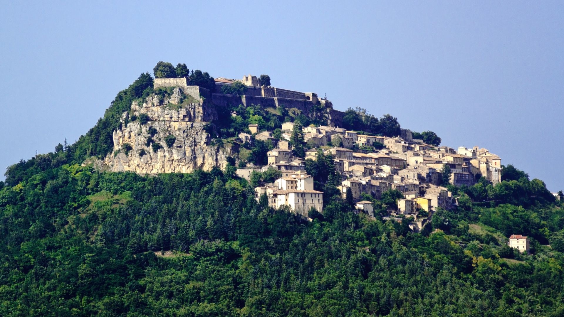 Image shows the Fortress of Civitella del Tronto perched on a rocky cliff in Italy's Abruzzo region.