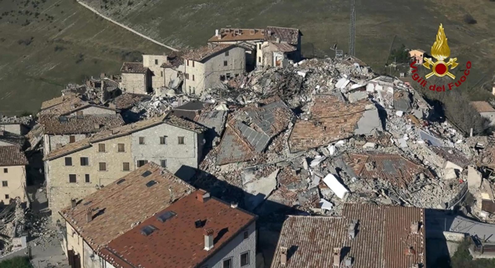 Collapsed buildings and debris in Norcia, Italy, following a powerful earthquake, showing the severe structural damage to historic architecture and the impact on the local community.