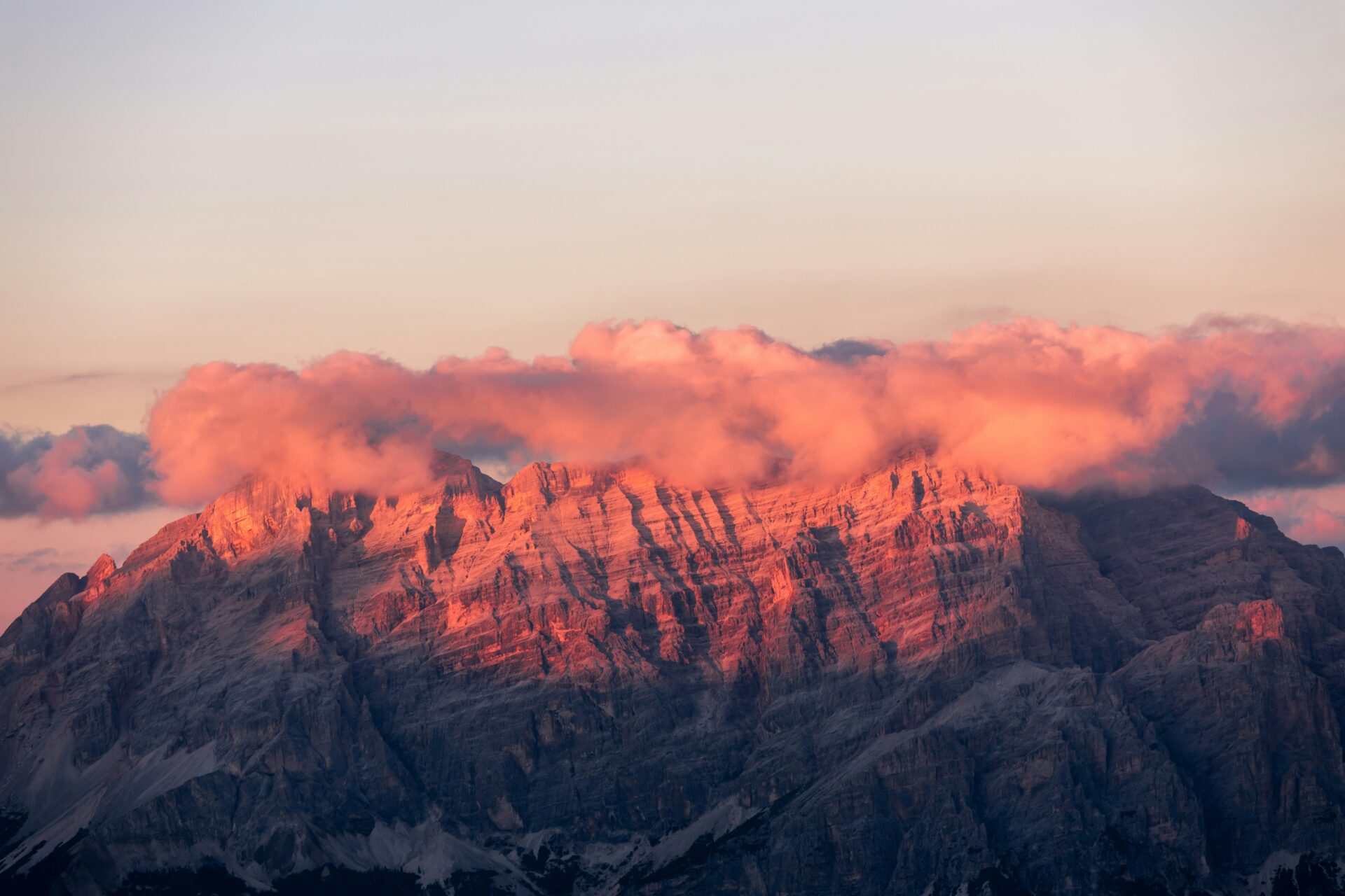 Dolomites Peaks during sunset with pinkish glow or alpenglow and fog