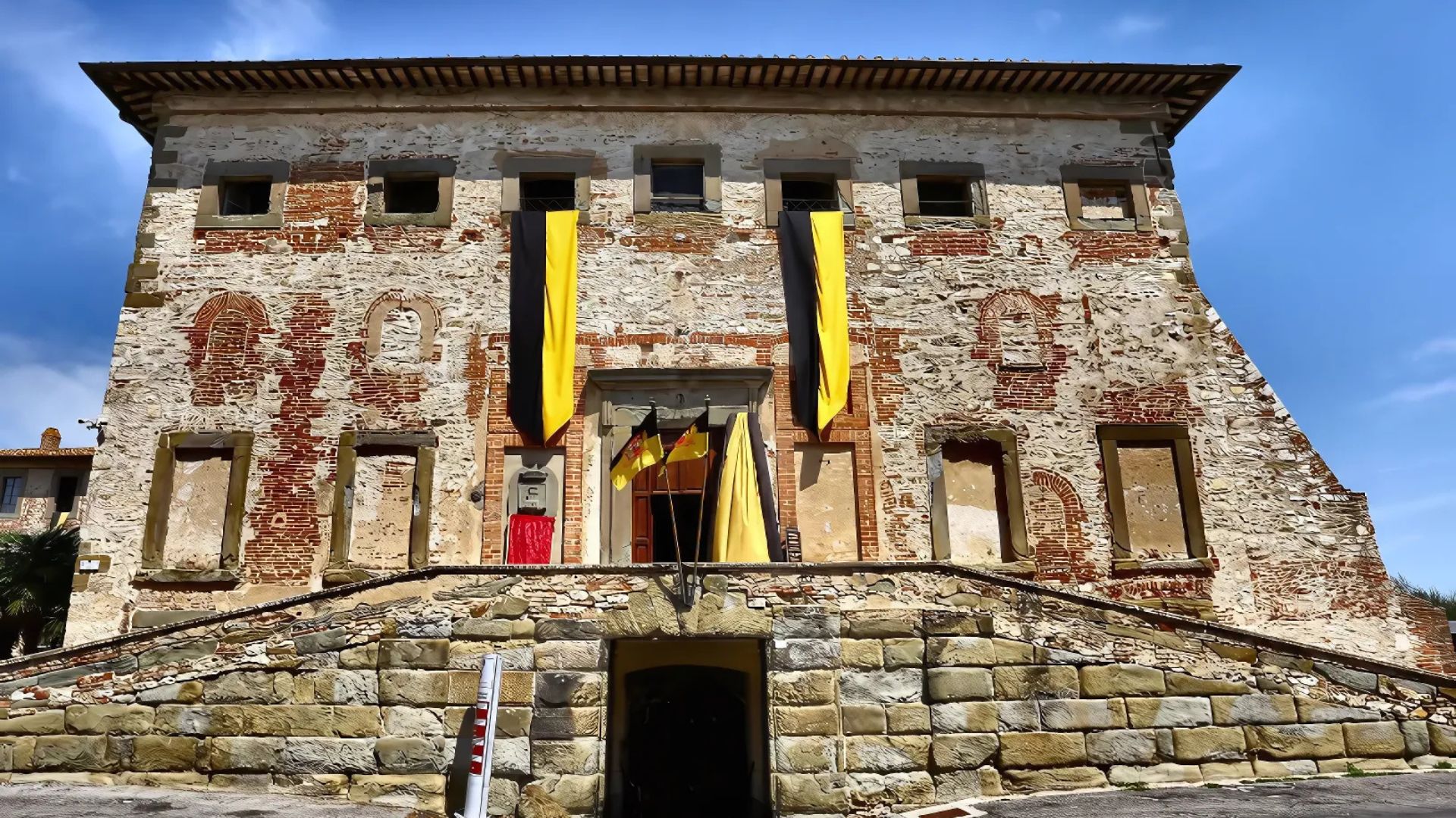 he building in the image is the Palazzo della Corgna, also known as the House of Della Corgna, located in Castiglione del Lago, Italy