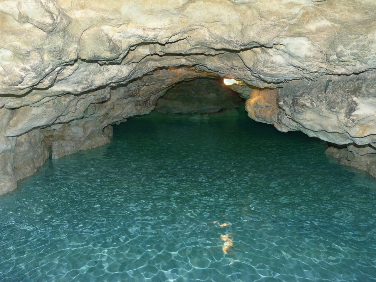 Grotto with crystal-clear water inside - cavern