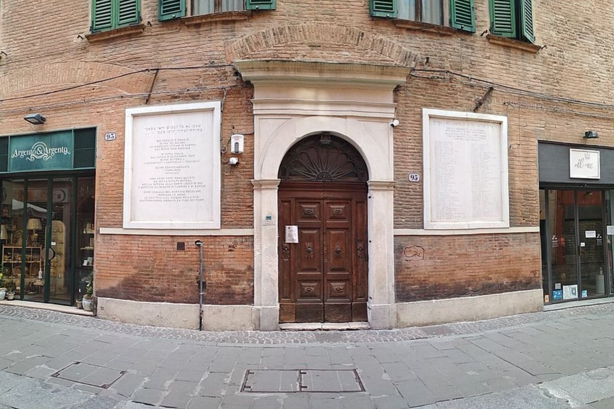 The image shows the Ferrara Synagogue, also known as Ghetto di Ferrara, located in Ferrara, Italy. Synagogues serve as places of worship, assembly, and study for Jewish people. In the past, Jewish residents in Ferrara were compelled to reside in a ghetto.