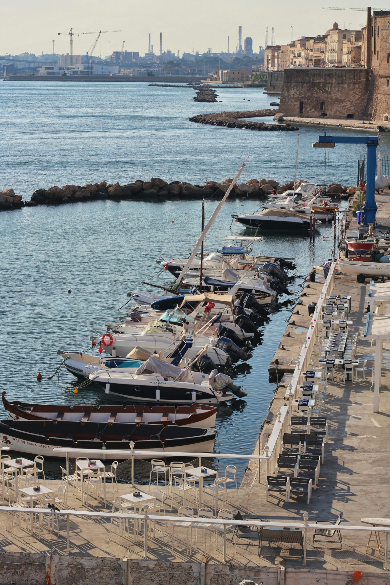 Scenic view of Mar Piccolo in Taranto, Italy, featuring calm waters dotted with small fishing boats