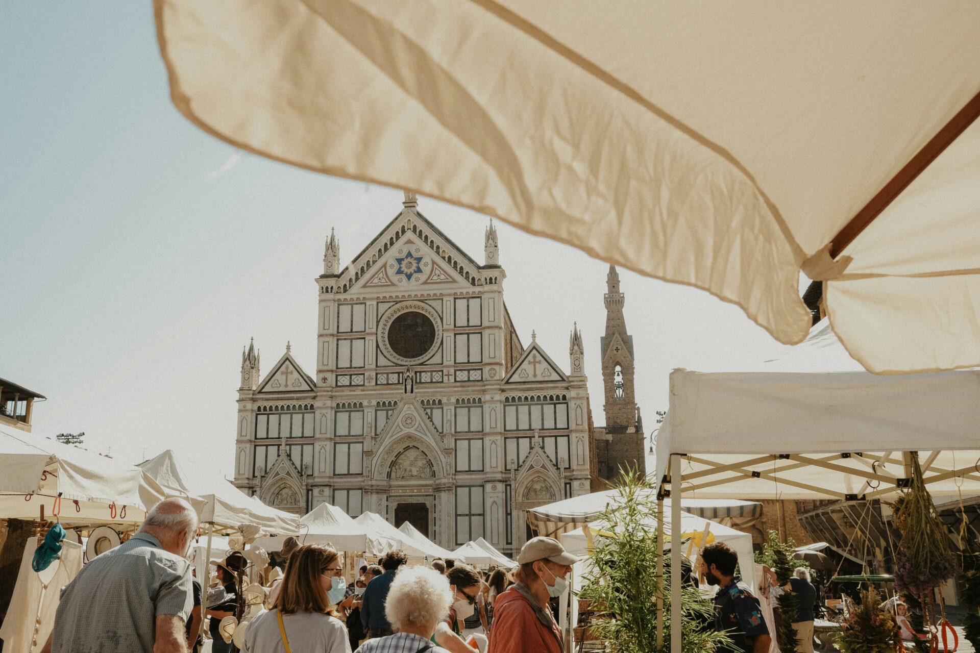 Market in Florence with a church backdrop