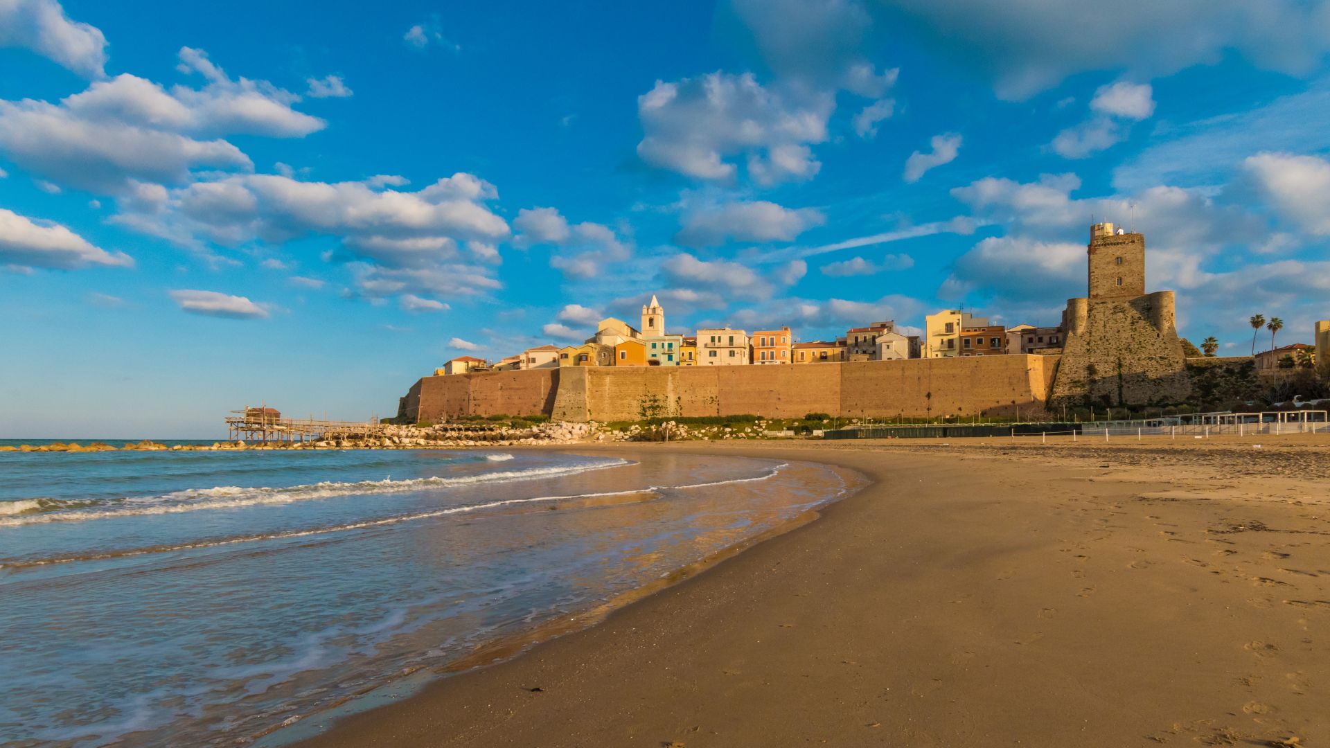 The image shows the ancient village of Termoli in the Molise region of Italy, specifically the Borgo Medievale di Termoli, featuring its fortified walls, Swabian castle, and cathedral
