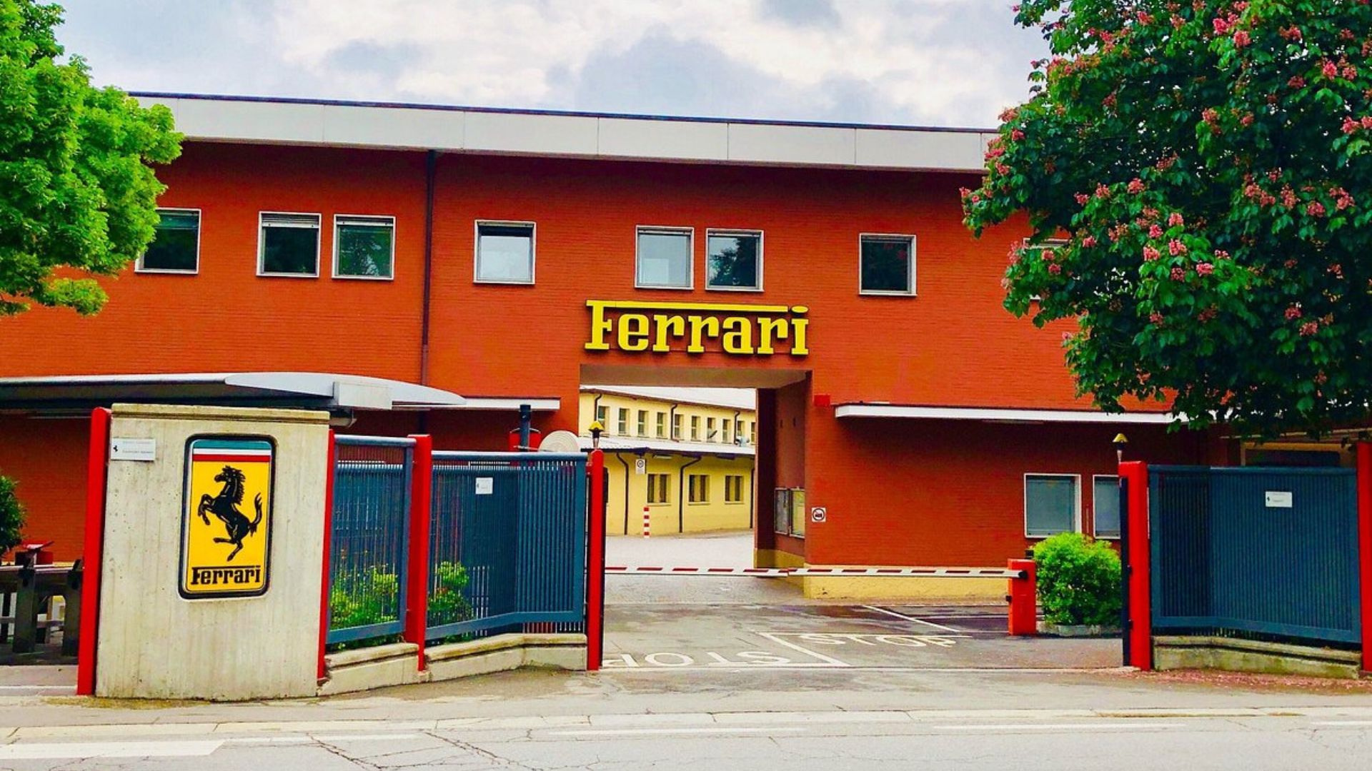 The image depicts the Ferrari Factory in Maranello, Italy.
