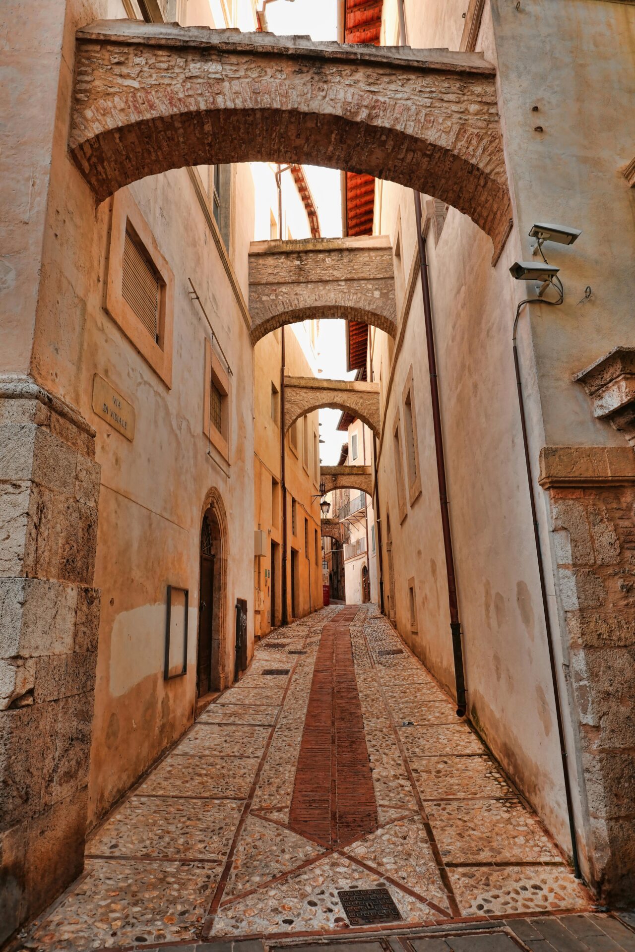 Narrow cobblestone alleyway in Spoleto, Umbria