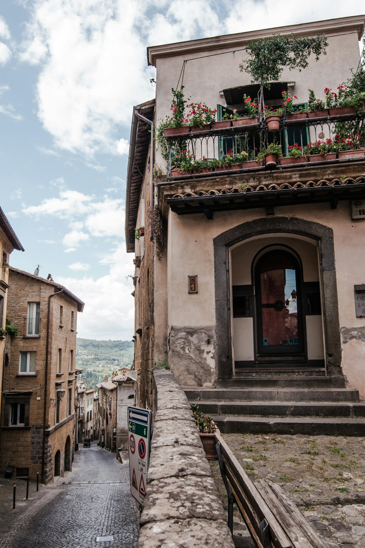 A charming narrow street in Orvieto, Italy, lined with rustic buildings and cobblestone paths