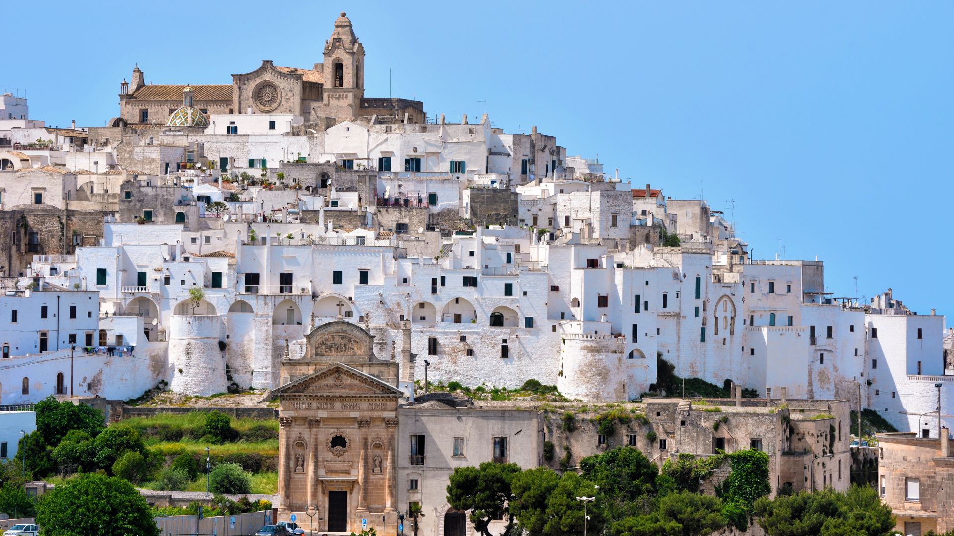 Image shows whitae washed houses in Ostuni, Itria Valley, Puglia, Italy