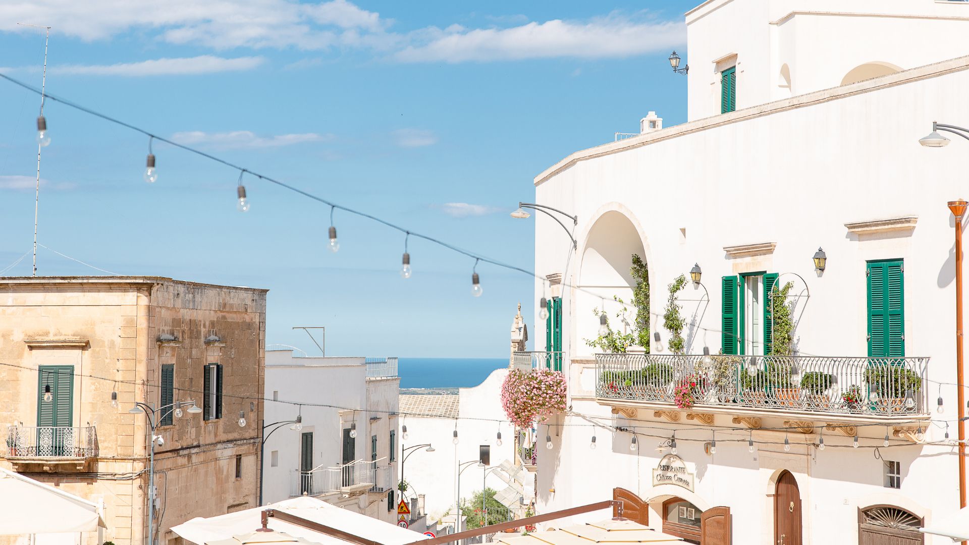The image shows white houses in Ostuni, Puglia, Italy.