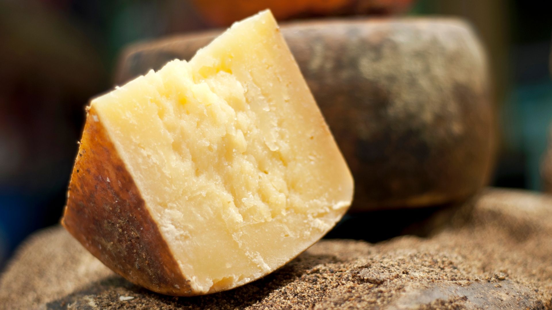 Image shows a sliced of Pecorino Stagionato.