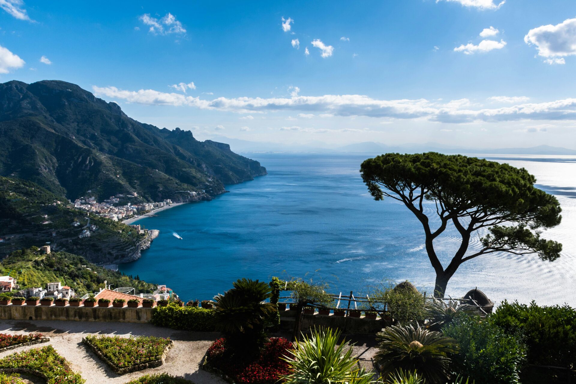 Scenic coastal view from a garden terrace in Ravello, Italy, overlooking the Amalfi Coast and the Mediterranean Sea.