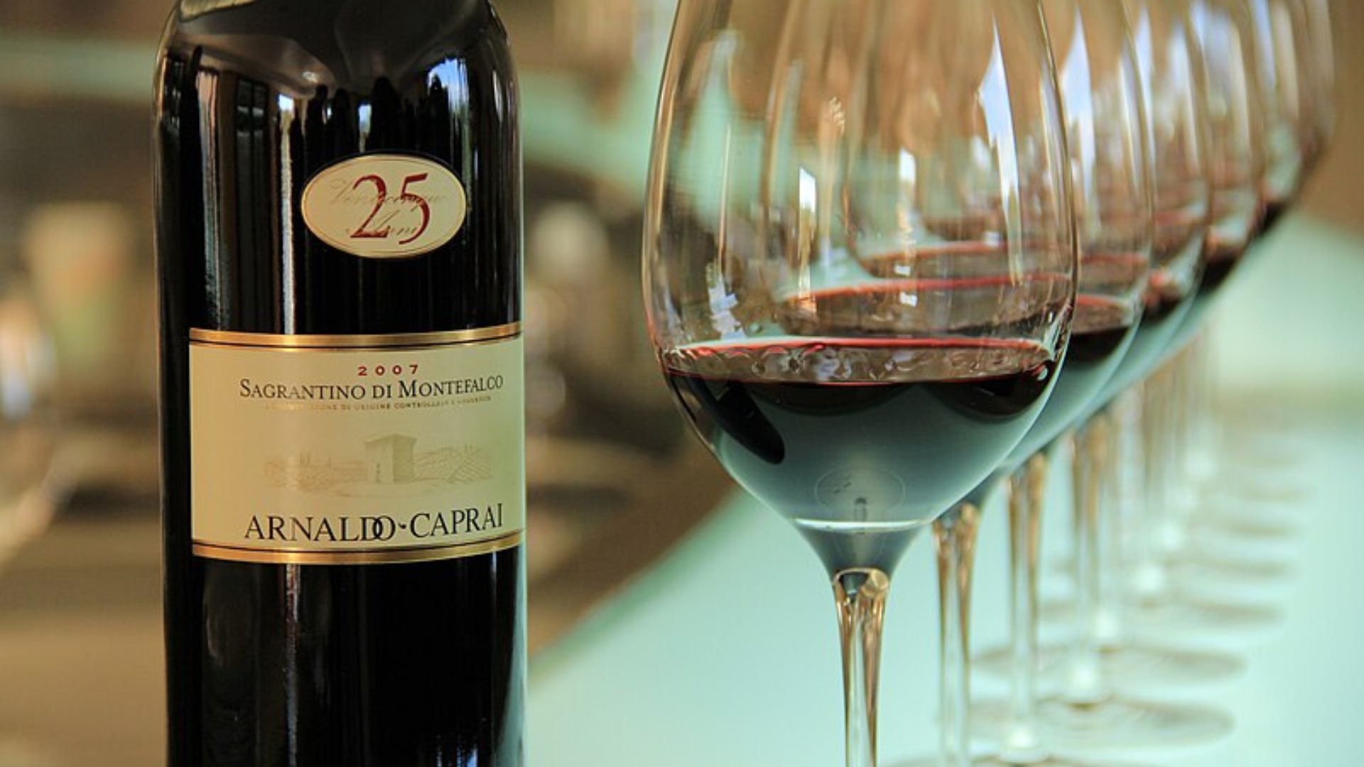 Image of Sagrantino di Montefalco wine bottle and wine glasses.