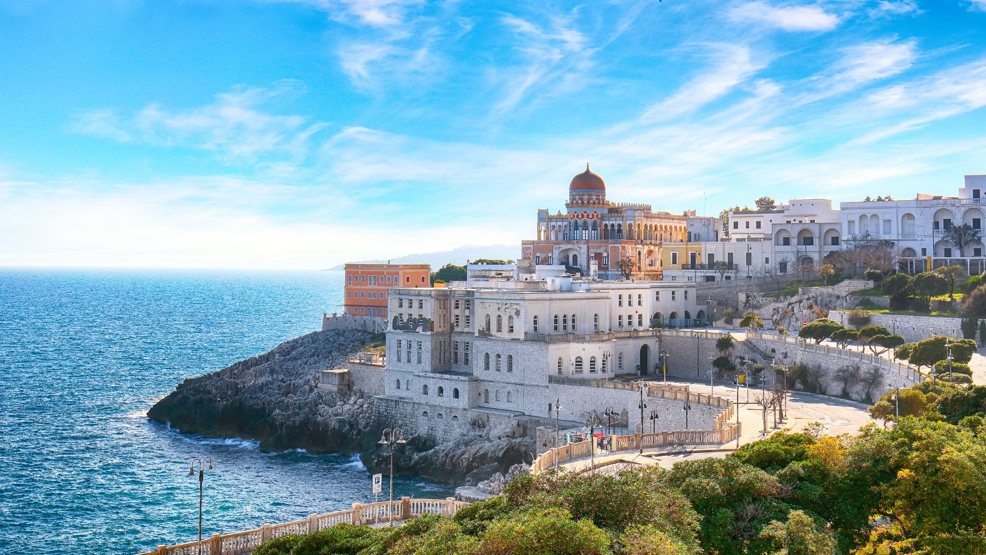 Image shows the town of Santa Cesarea Terme, Italy located on a plateau, overlooking the Adriatic Sea.