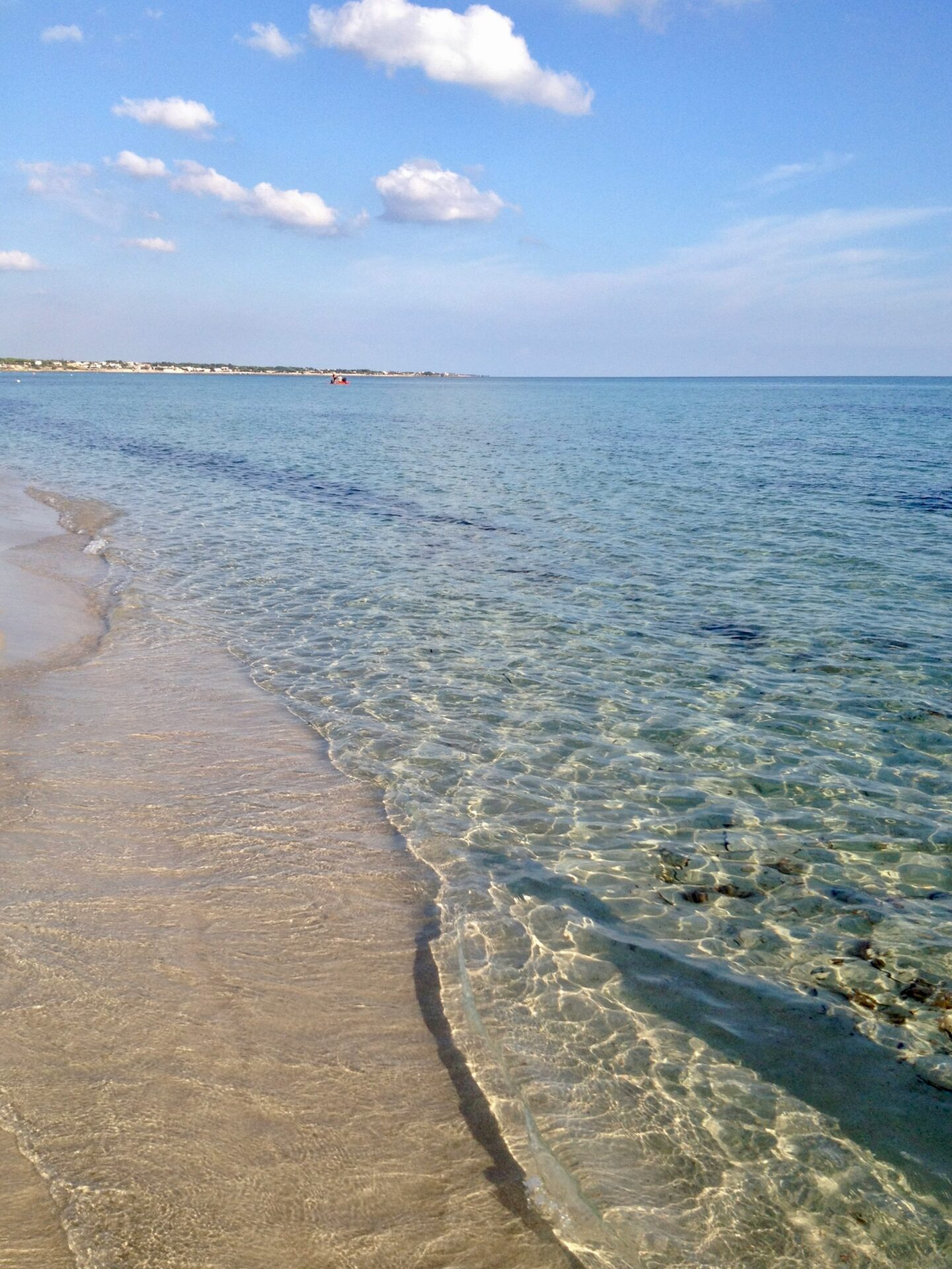 Coastal view of Taranto, Italy, with clear turquoise waters