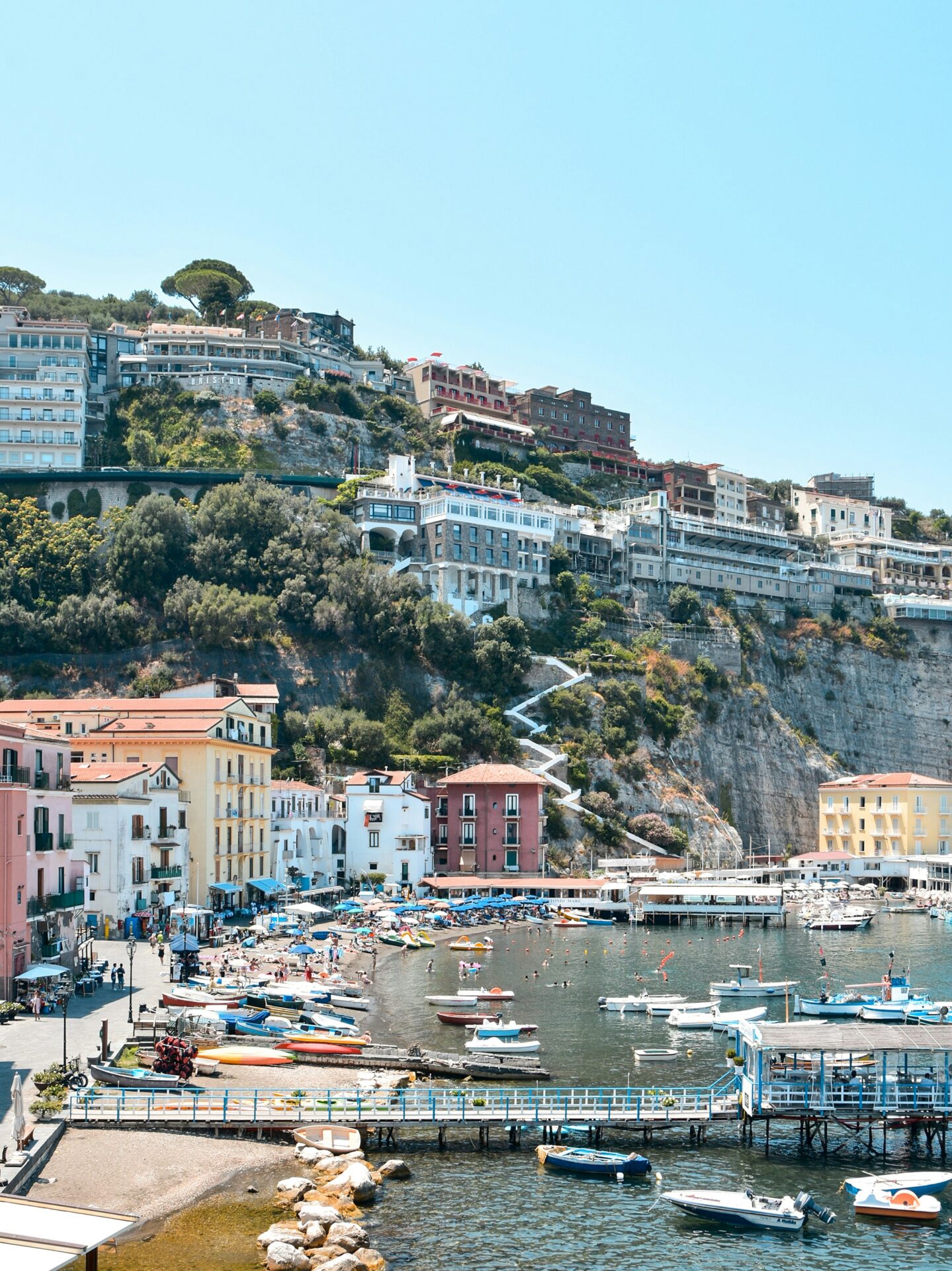 Scenic view of colorful buildings and the coastline in Sorrento, Metropolitan City of Naples, Italy, overlooking the clear blue waters of the Tyrrhenian Sea.