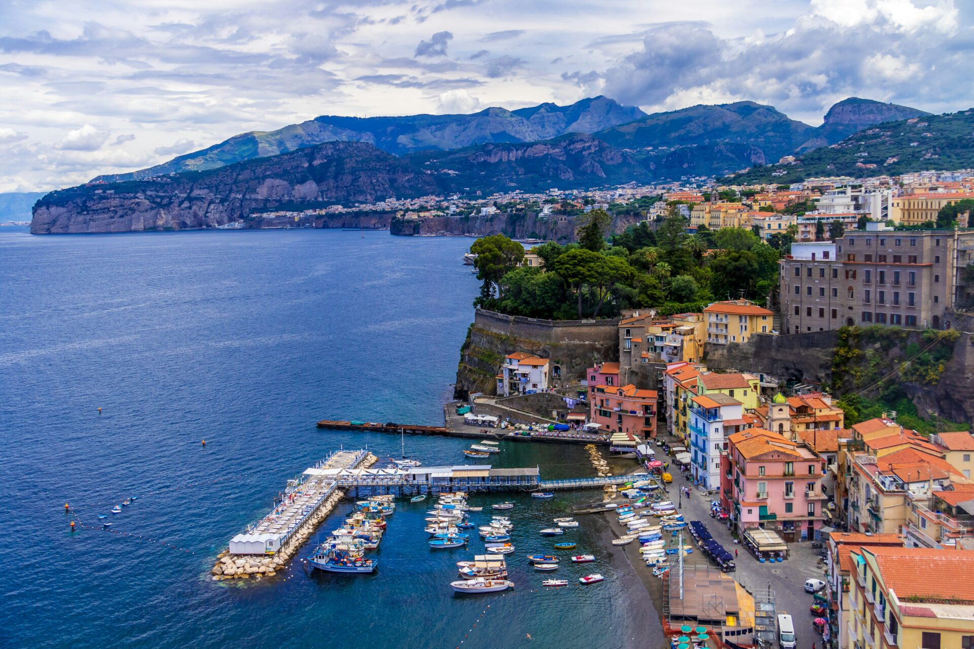 Fishing boats and houses that make up the harbour at Sorrento, Italy.