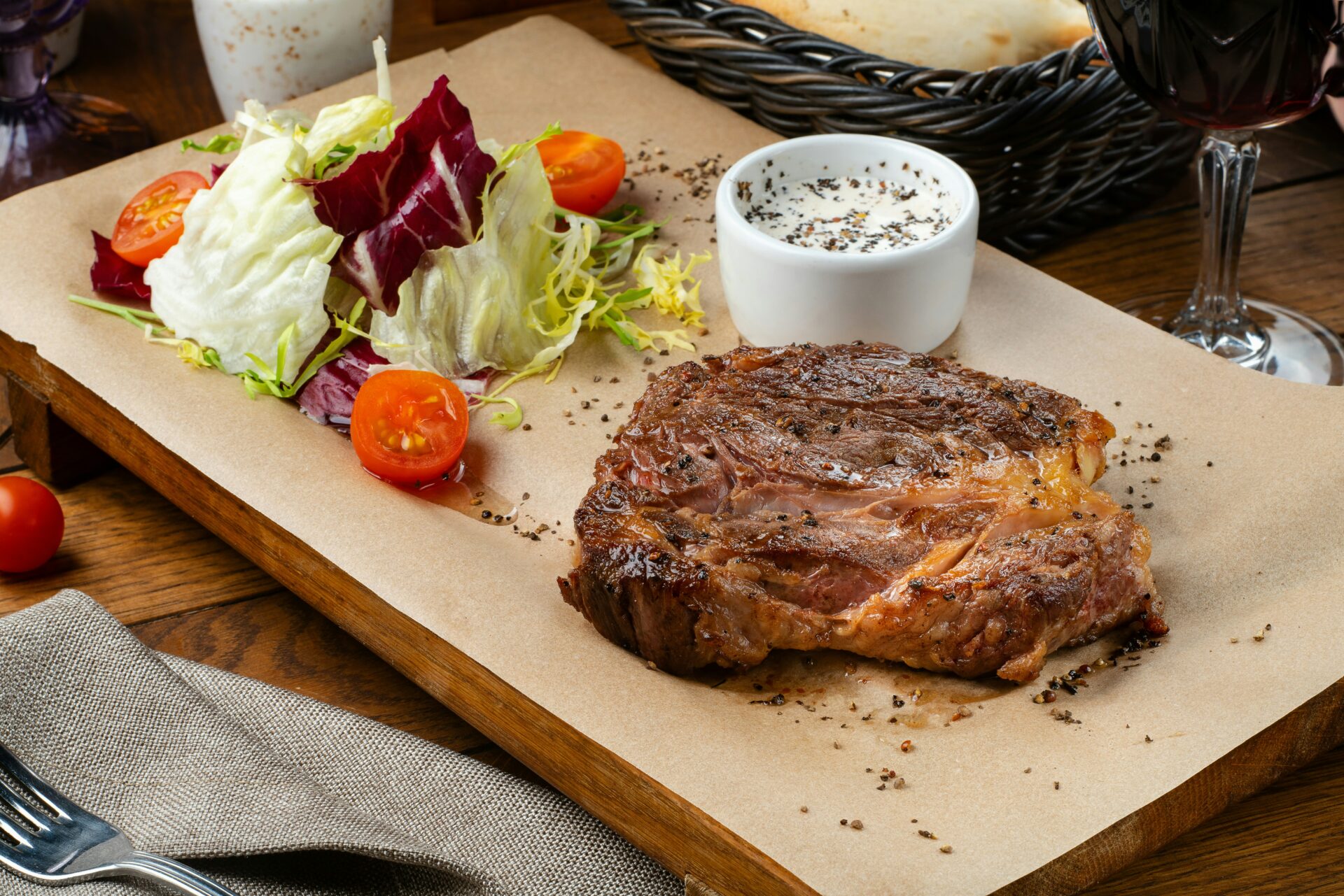 Steak and salad on cutlery board