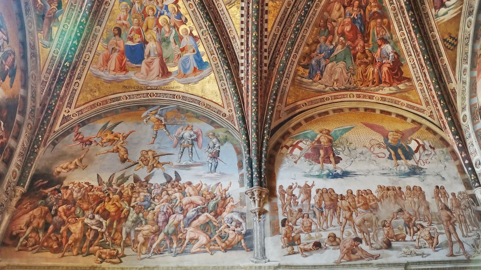 The image shows a section of the fresco cycle "The Last Judgment" by Luca Signorelli, located in the San Brizio Chapel within the Orvieto Cathedral in Orvieto, Umbria, Italy.