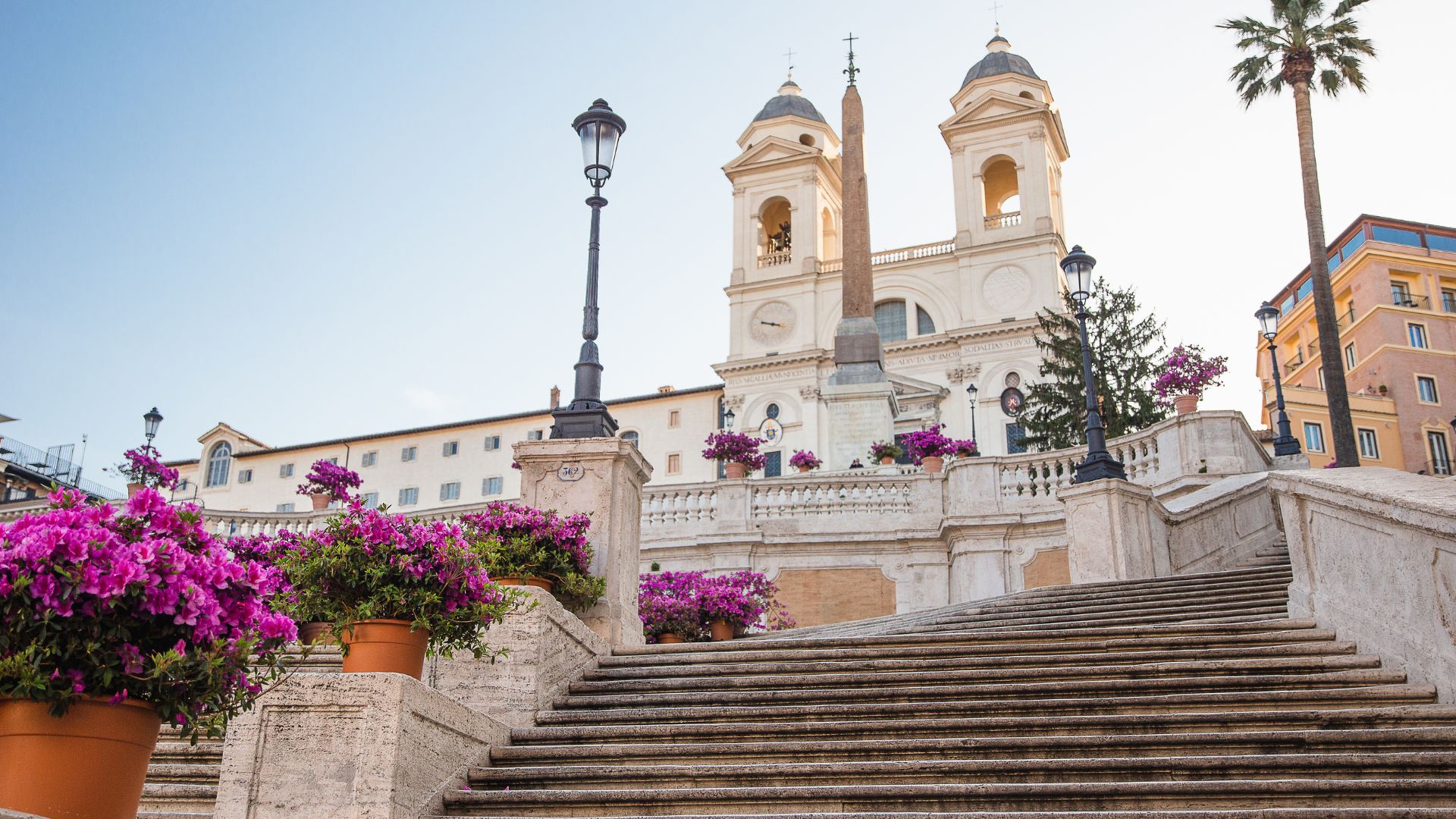 Image shows colorful flowers on The Spanish Steps in Rome