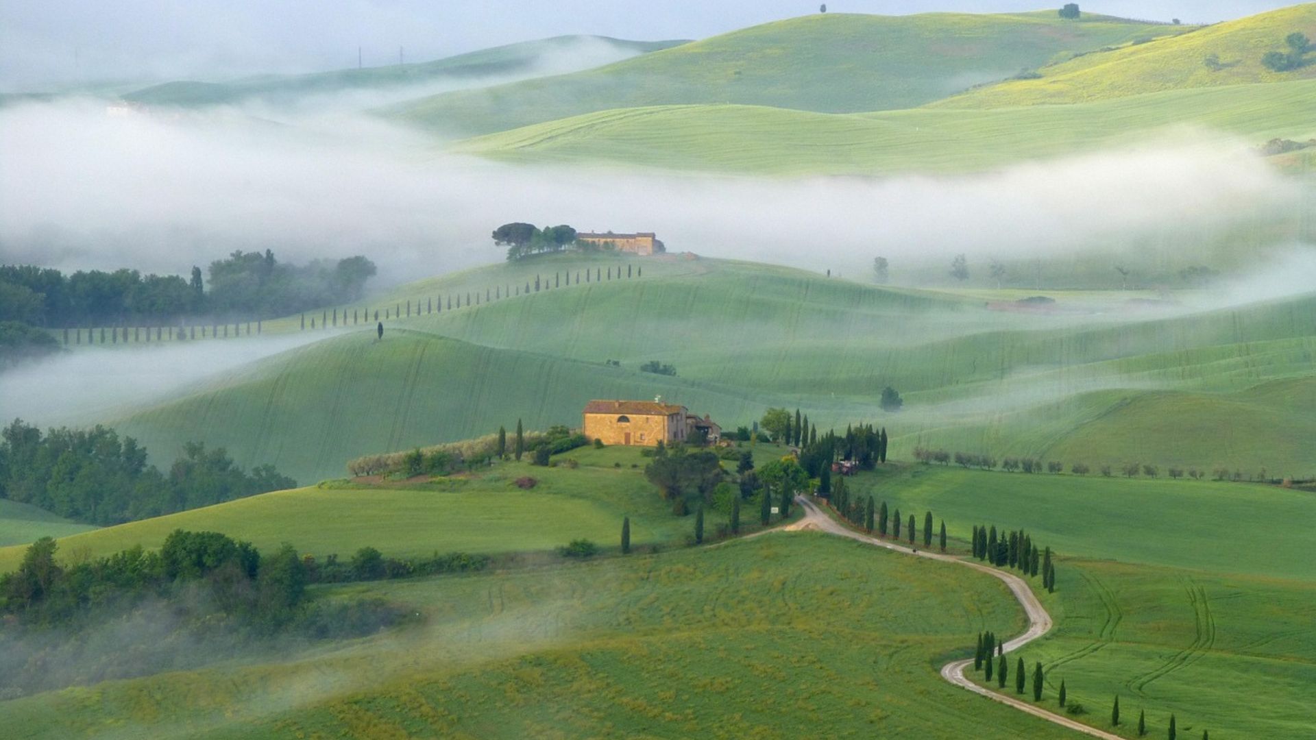 Image shows beautiful landscape featuring flat chalk plains and hills with fortified settlements of The Val d'Orcia