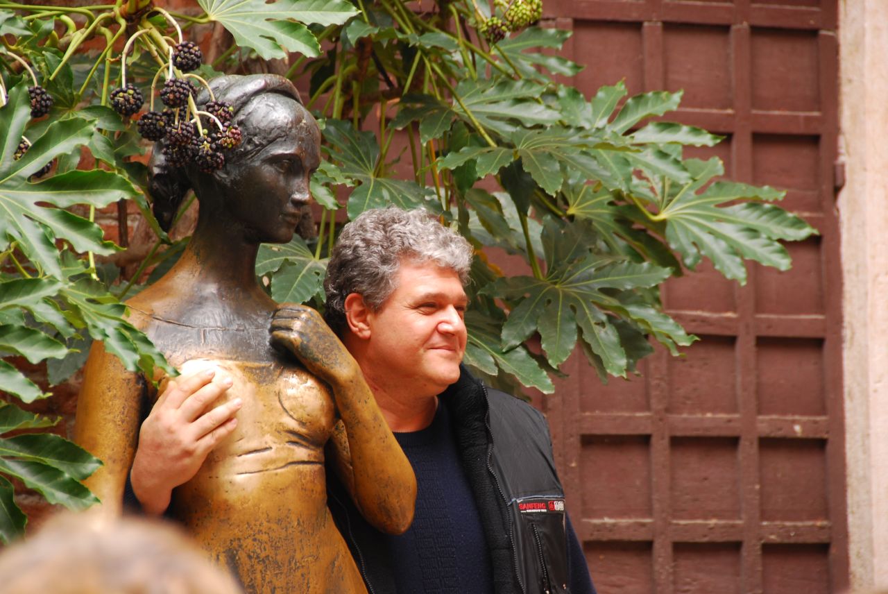 Touching Juliet's right breast