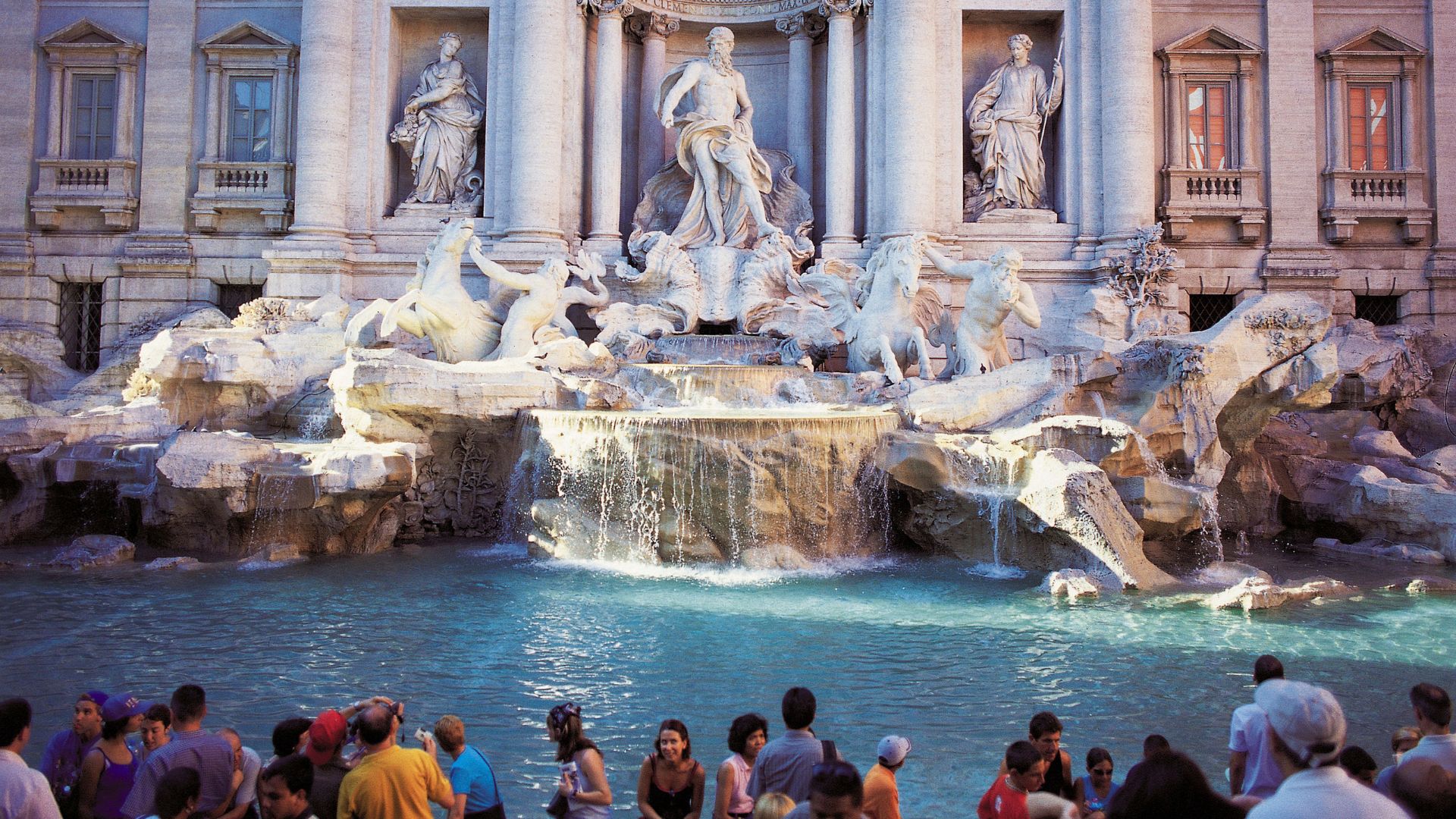 Image of The Trevi Fountain, Rome with some people around it.