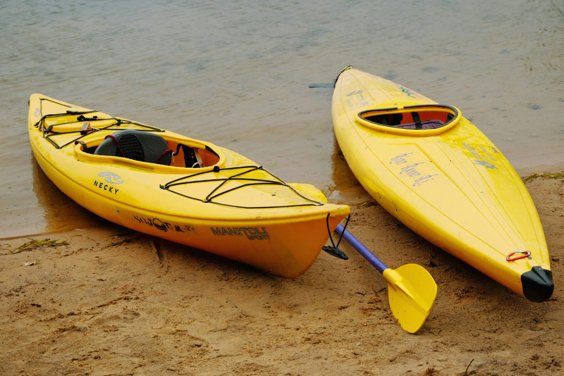 Two yellow kayak boats standby