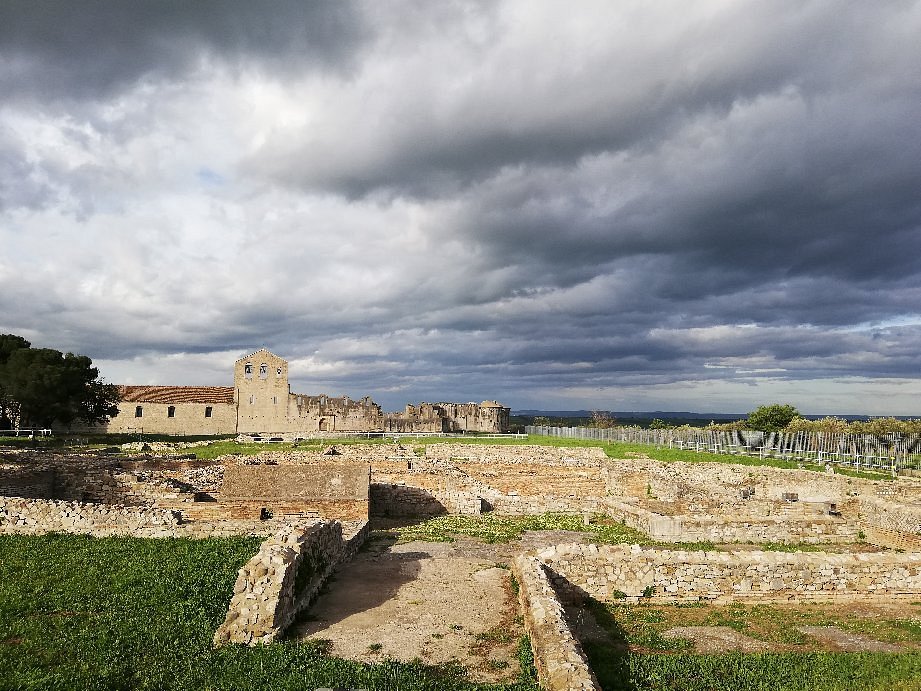 Ancient stone walls and column fragments at the Venosa archaeological park